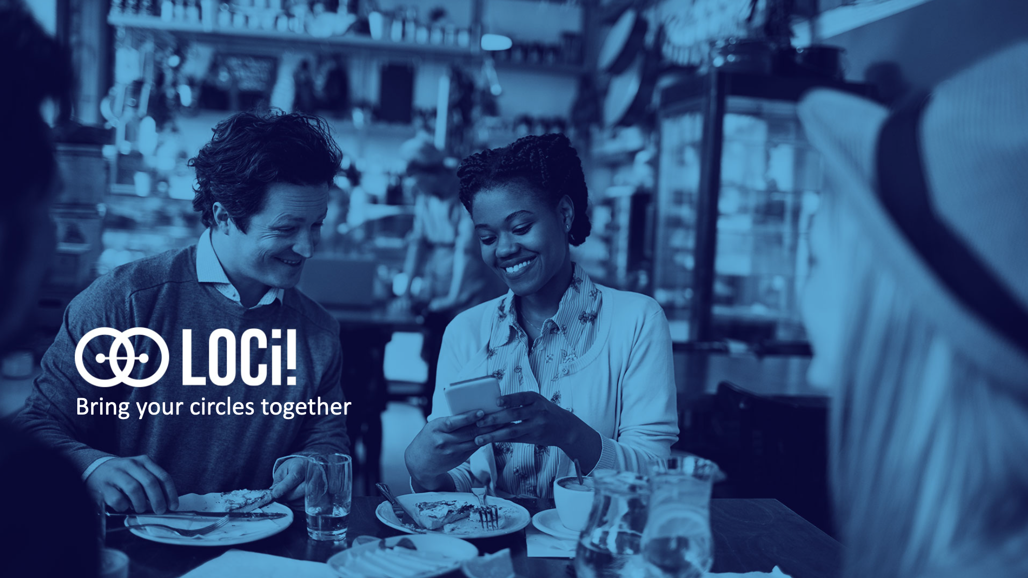 Photo of two people looking at their phone.